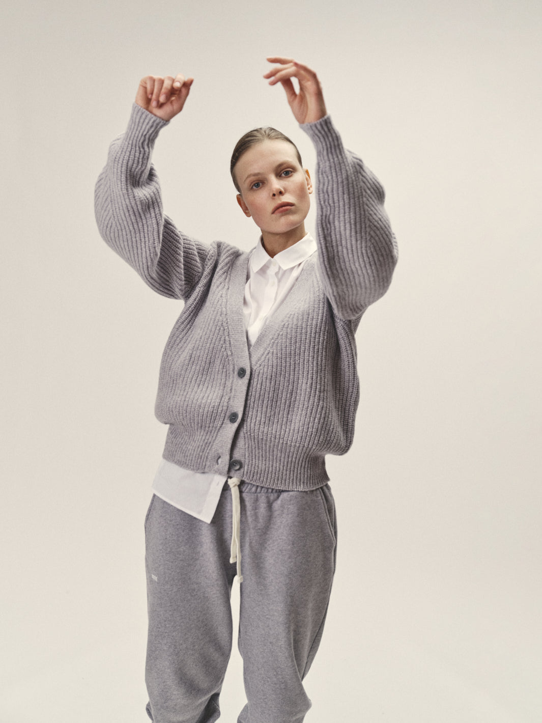 Damen Trick Cardigan in Grau Melange aus nachhaltiger Merino Wolle von WOTE - hochwertig in Italien hergestellt, Frontansicht mit Studioaufnahme